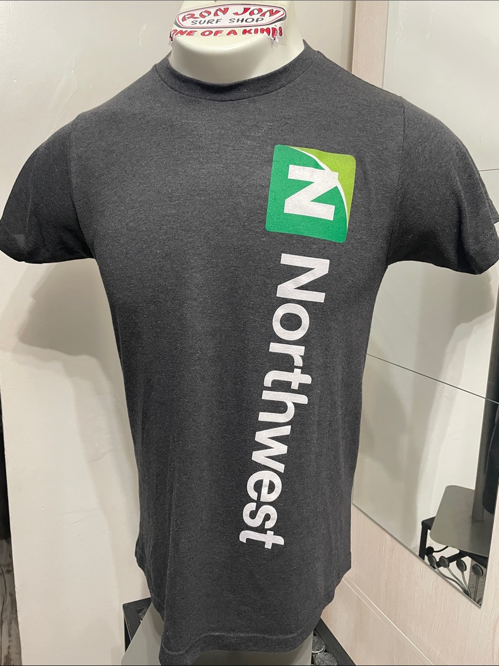 Northwest Black Tee with Green Logo and White Vertical Text